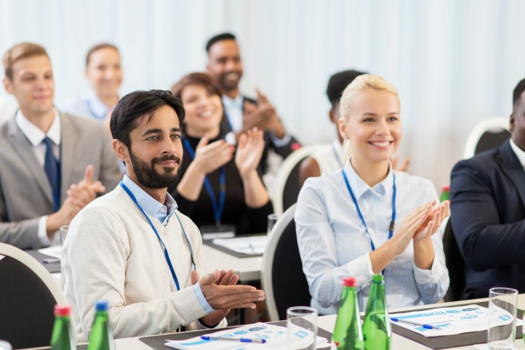 people applauding at business conference